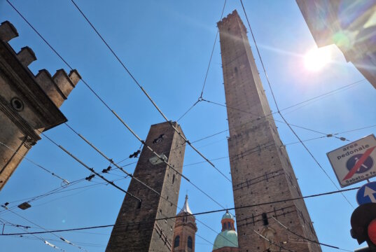 Die beiden Türme aus der Nähe: Torre Garisenda (links) deutlich geneigt, Torre Asinelli (rechts) mit über 97 m die höchste mittelalterliche Turmstruktur Italiens. (Foto: © Bastian Glumm)