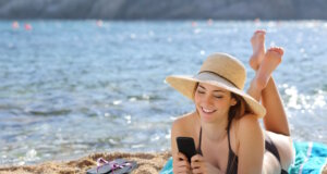 Es könnte so schön einfach sein: ein Smartphone, ein Strand in Italien und das Geld kommt von allein. Die Realität sieht meist etwas anders aus. (Foto: © Antonioguillem / Adobe Stock)