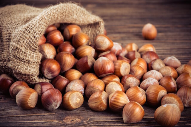 hazelnuts on wooden background Italienische Haselnüsse: Wegen Frost, Hitze und Schädlingsbefall droht 2025 eine deutlich kleinere Ernte – mit Folgen für die Süßwarenindustrie und Produkte wie Nutella. (Foto: © Andreas Fischer /Adobe Stock)